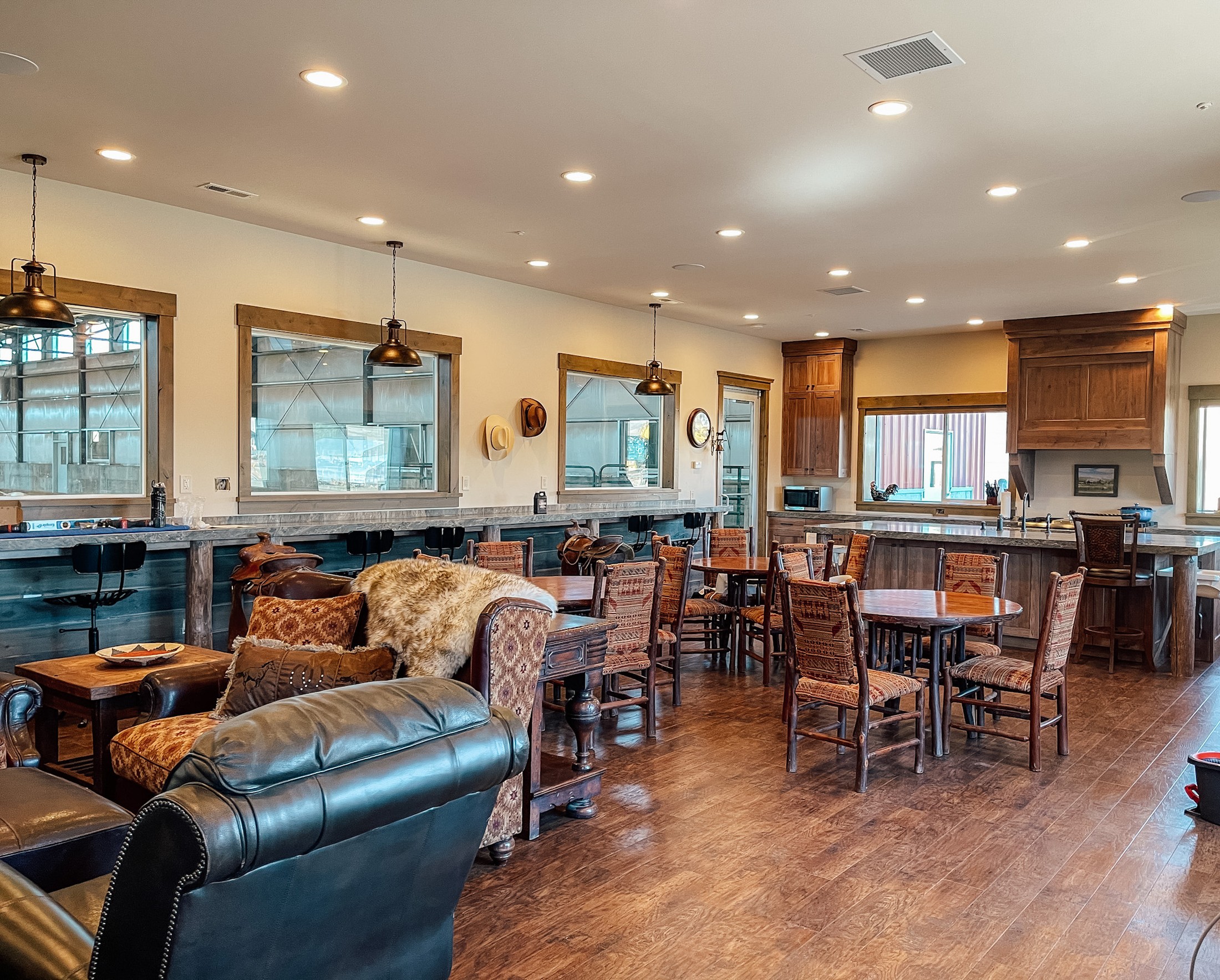 The lodge common room at Warrior Rizen Ranch — timber, leather, and western hospitality